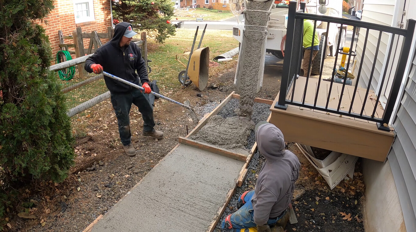 Professional concrete walkway finishing work in progress